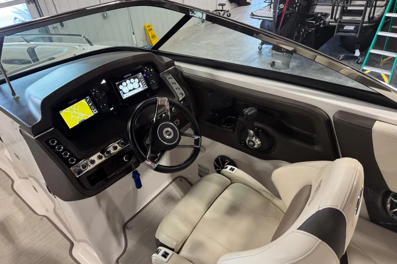 Slide: The Image of 2019 Chaparral 257 SSX boat cockpit with modern dashboard and steering wheel. - 11