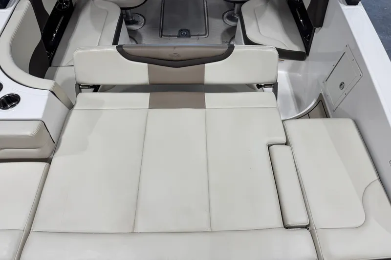 Slide: The Image of 2019 Chaparral 257 SSX boat interior with beige seating and cup holders. - 12