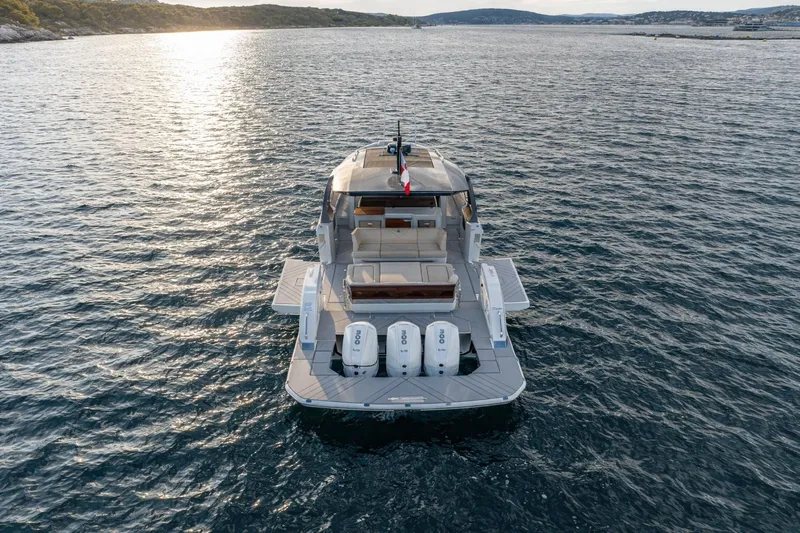 Slide: The Image of 2024 Wiszniewski Yachts W43 on serene water at sunset, rear view. - 6