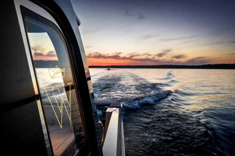 Slide: The Image of Wiszniewski Yachts W43 cruising at sunset, 2026 model, reflecting serene waterscape. - 3