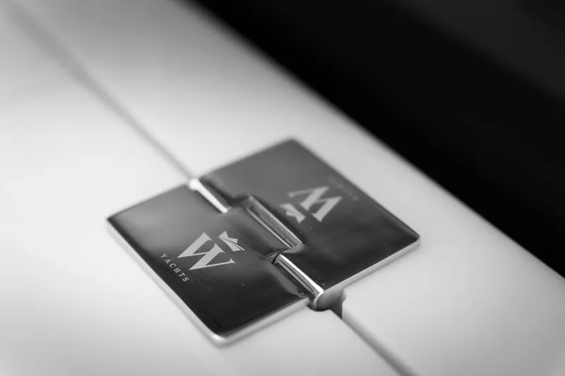 Slide: The Image of Close-up of Wiszniewski Yachts W43 2026 model logo on a metallic hinge. - 4