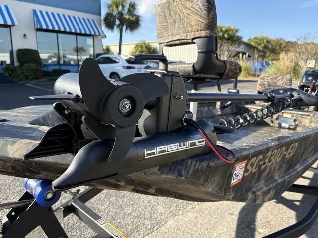 Slide: The Image of Crestliner 1546 Retriever Jon 2022 with Haswing motor, parked outdoors. - 13