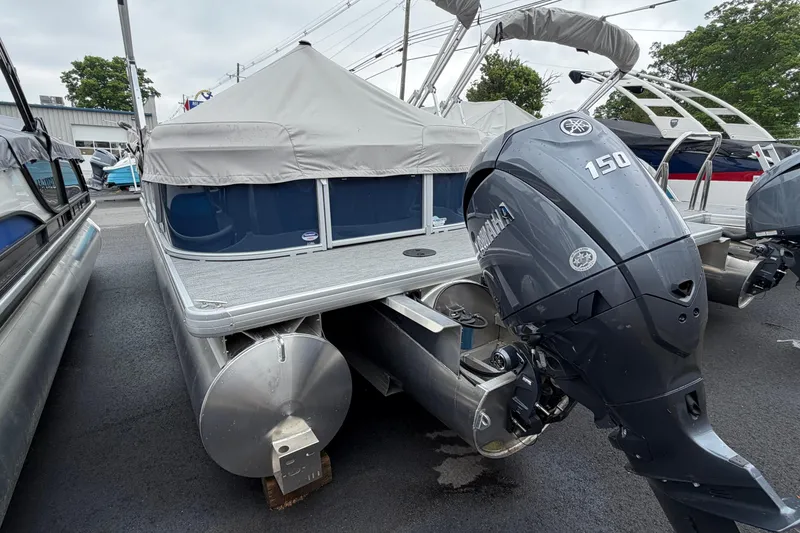 Slide: The Image of 2026 Godfrey EX2286SBX pontoon boat with Yamaha 150 engine, covered and docked. - 12