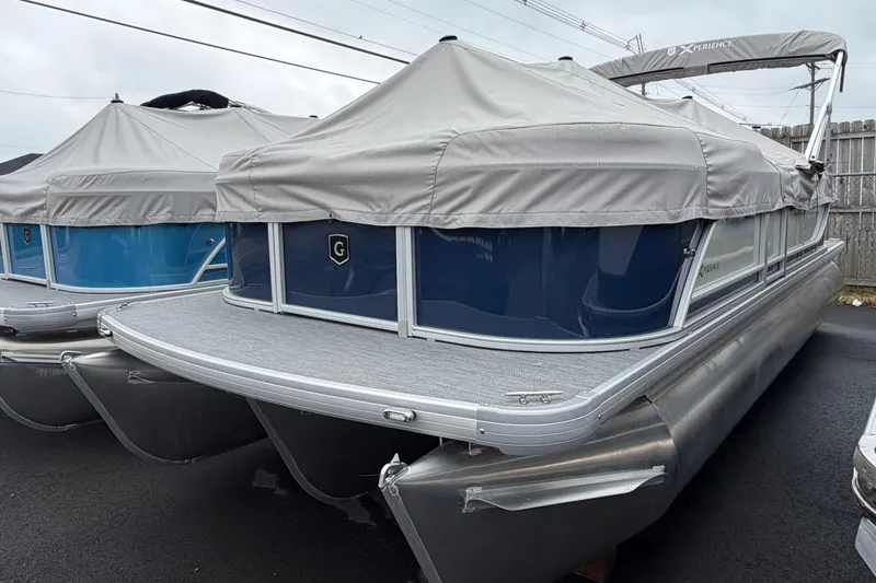 Slide: The Image of 2026 Godfrey EX2286SBX pontoon boat with gray cover, parked outdoors. - 8