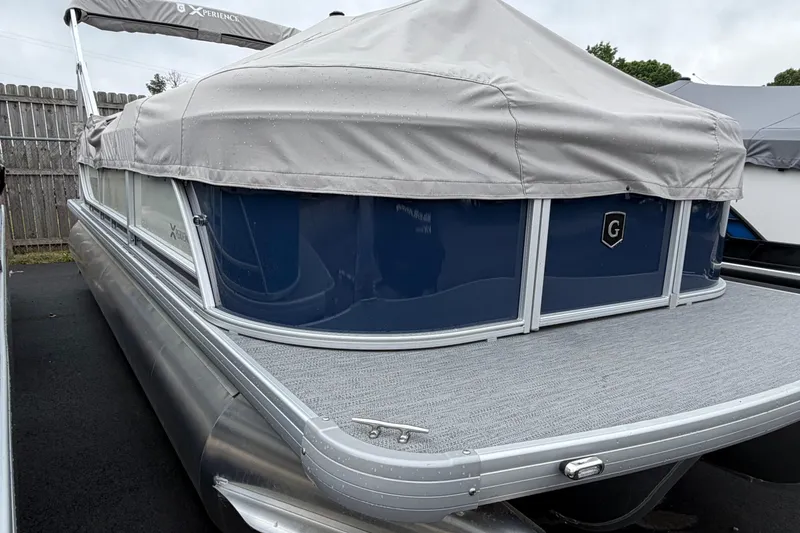 Slide: The Image of 2026 Godfrey EX2286SBX pontoon boat with gray cover and blue accents. - 9