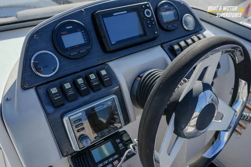 Slide: The Image of 2018 Starcraft MDX 190 O/B boat dashboard with steering wheel and control panel. - 23