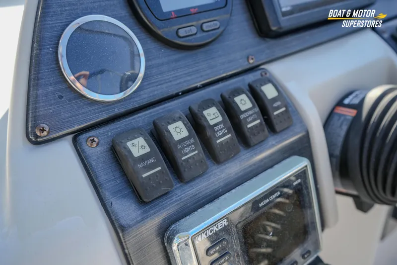 Slide: The Image of Control panel of 2018 Starcraft MDX 190 O/B boat with labeled switches and media center. - 24