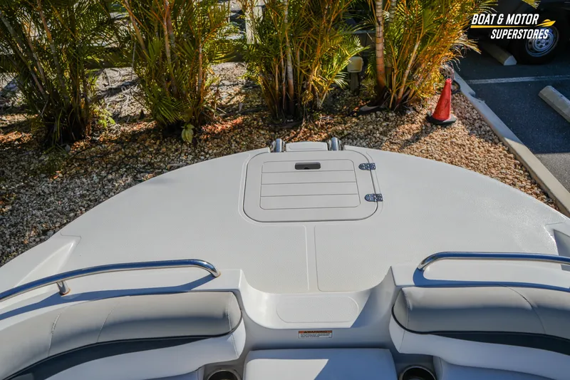 Slide: The Image of 2018 Starcraft MDX 190 O/B boat deck with seating, surrounded by tropical plants. - 27