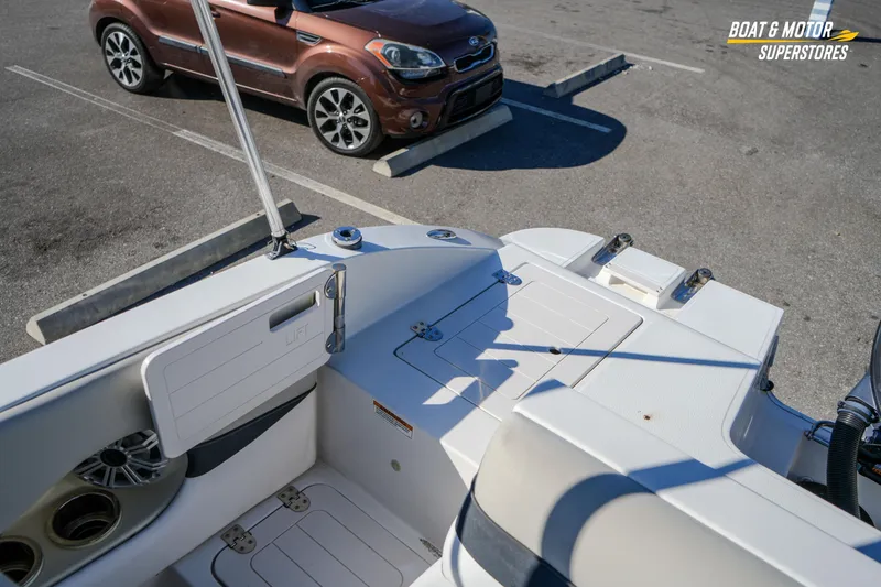 Slide: The Image of 2018 Starcraft MDX 190 O/B boat interior with parked car in background. - 33