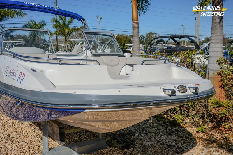 Slide: The Image of 2018 Starcraft MDX 190 O/B boat displayed outdoors with palm trees. - 4