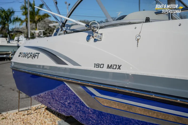 Slide: The Image of 2018 Starcraft MDX 190 O/B boat displayed at dealership, featuring sleek design and branding. - 5