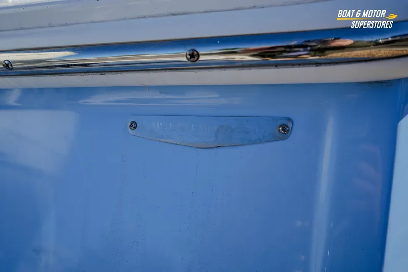 Slide: The Image of 2025 Blackfin 242 HB boat detail with blue hull and metal plate. - 12