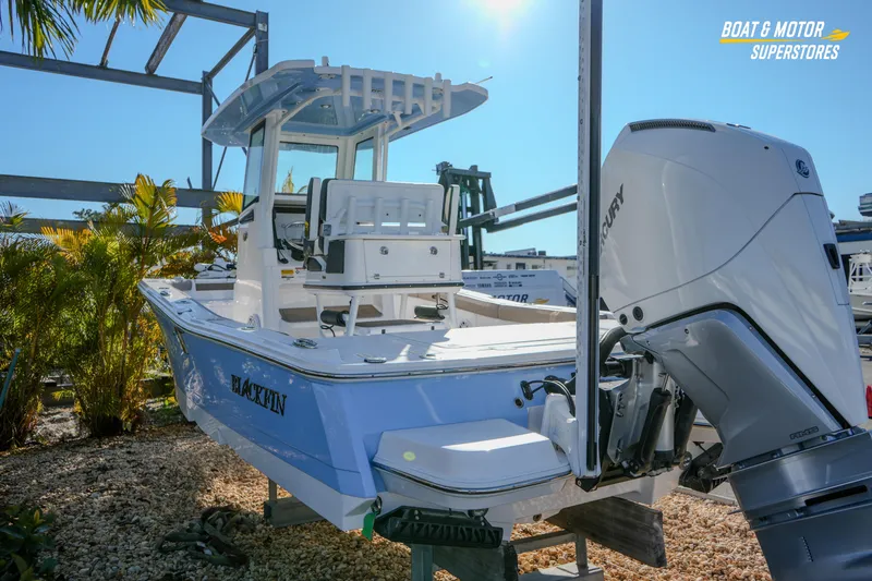 Slide: The Image of 2025 Blackfin 242 HB boat with Mercury engine, displayed outdoors at a dealership. - 16