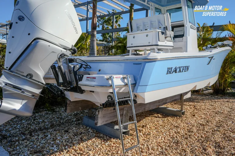Slide: The Image of 2025 Blackfin 242 HB boat with Mercury engine on display at dealership. - 19