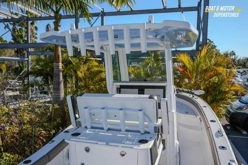 Slide: The Image of 2025 Blackfin 242 HB boat with sleek design, surrounded by tropical plants. - 21