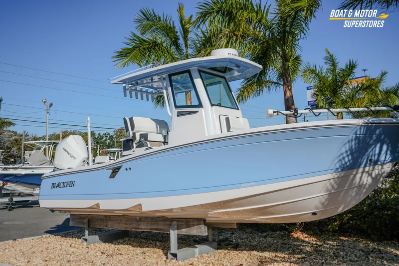 Slide: The Image of 2025 Blackfin 242 HB boat displayed outdoors with palm trees in the background. - 3