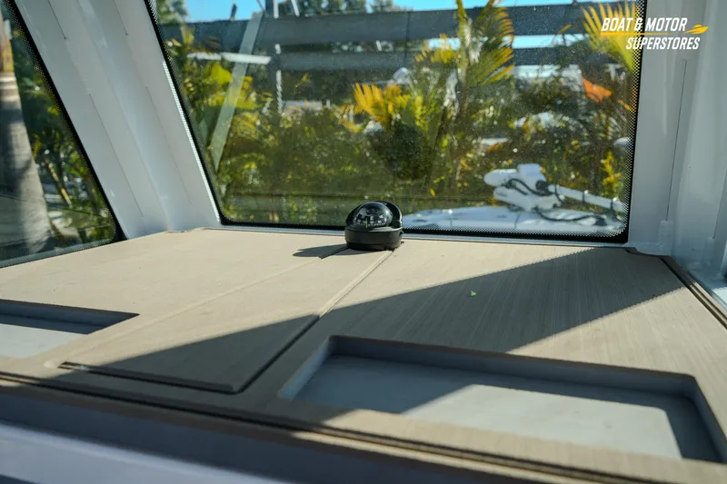 Slide: The Image of 2025 Blackfin 242 HB boat interior with compass and scenic view. - 30
