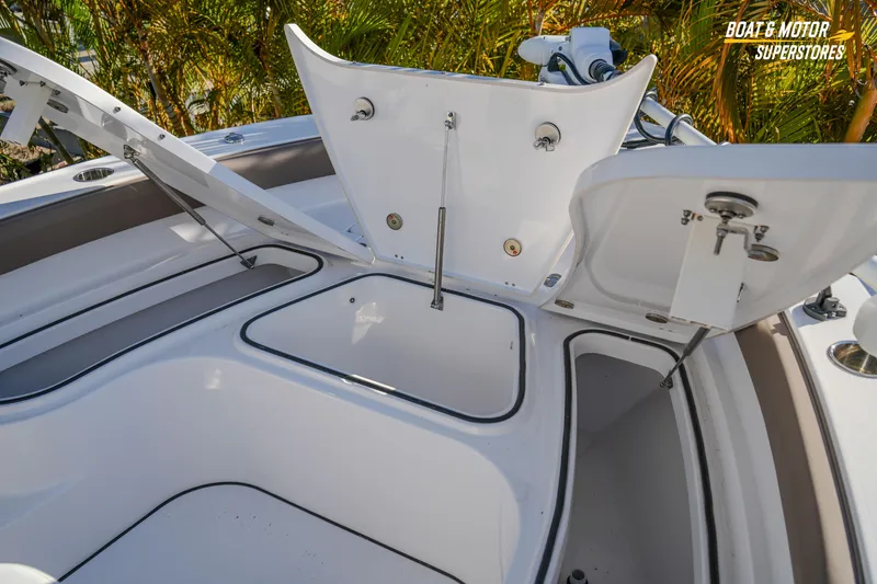 Slide: The Image of 2025 Blackfin 242 HB boat storage compartments open, showcasing spacious design. - 34
