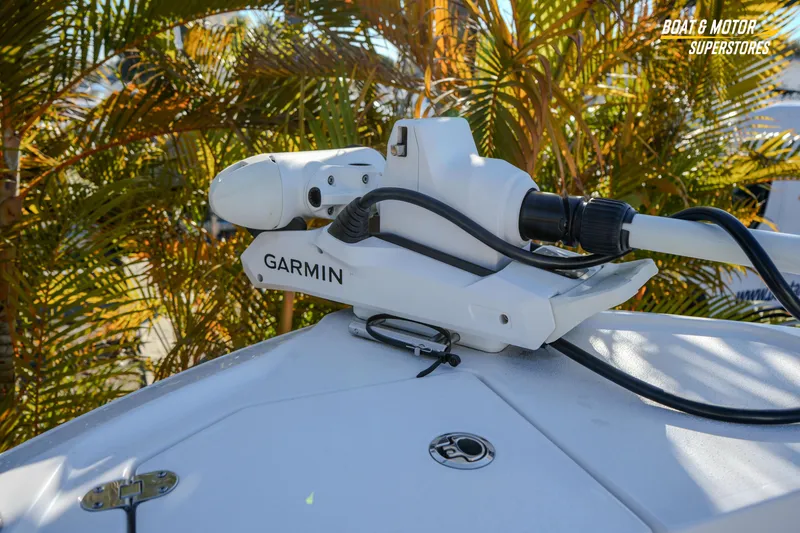Slide: The Image of Garmin equipment on 2025 Blackfin 242 HB boat, surrounded by tropical foliage. - 35