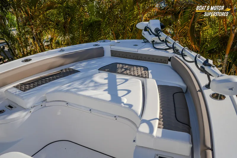 Slide: The Image of 2025 Blackfin 242 HB boat interior with cushioned seating and fishing rod holders. - 42