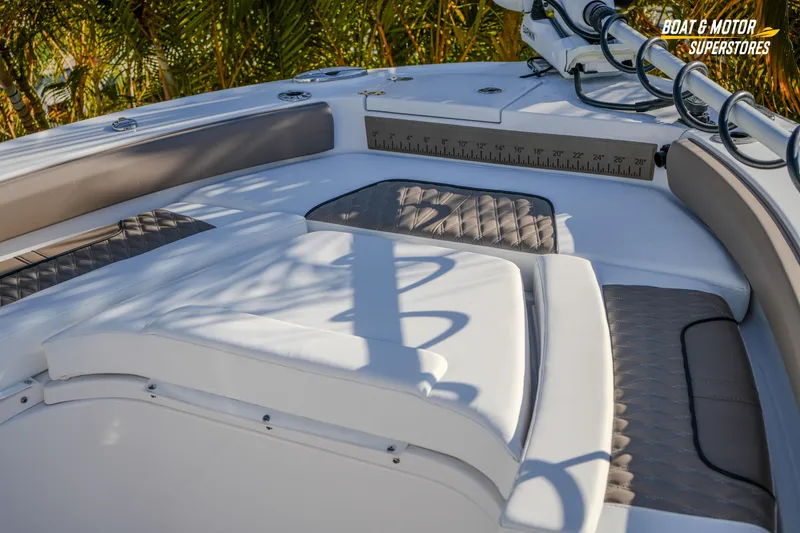 Slide: The Image of 2025 Blackfin 242 HB boat interior with cushioned seating and measuring ruler. - 43