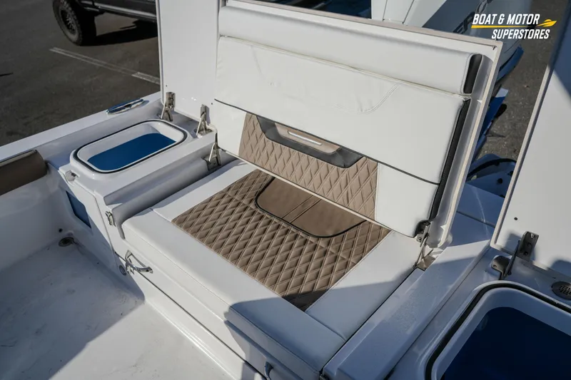 Slide: The Image of 2025 Blackfin 242 HB boat interior with cushioned seating and storage compartments. - 52