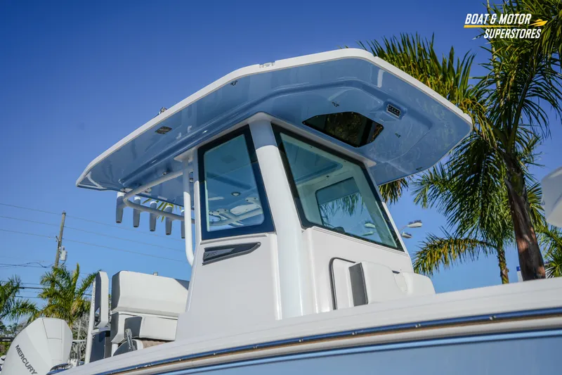Slide: The Image of 2025 Blackfin 242 HB boat with T-top, palm trees in background. - 6