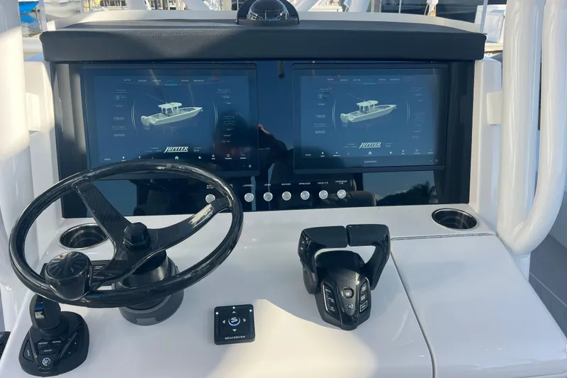 Slide: The Image of Helm of 2026 Jupiter 32 boat with dual screens and steering wheel. - 4