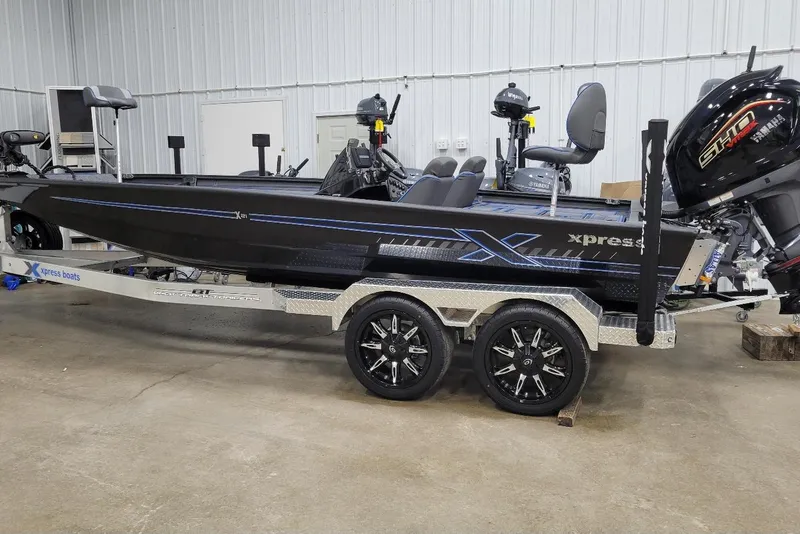 The Image of 2026 Xpress X21 Pro boat on trailer in indoor storage facility. - 1