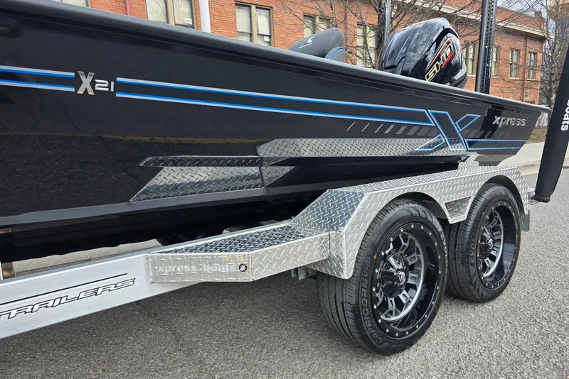 Slide: The Image of 2026 Xpress X21 Pro boat on a trailer with stylish wheels and sleek design. - 10