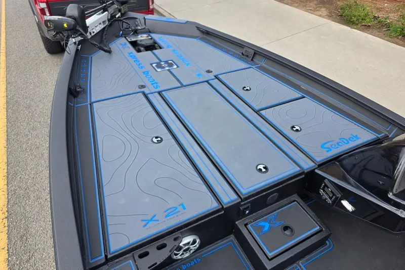 Slide: The Image of 2026 Xpress X21 Pro boat deck with SeaDek flooring, featuring storage compartments. - 12