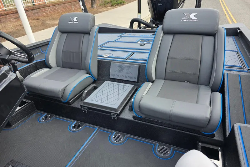 Slide: The Image of 2026 Xpress X21 Pro boat interior with dual gray seats and blue accents. - 15