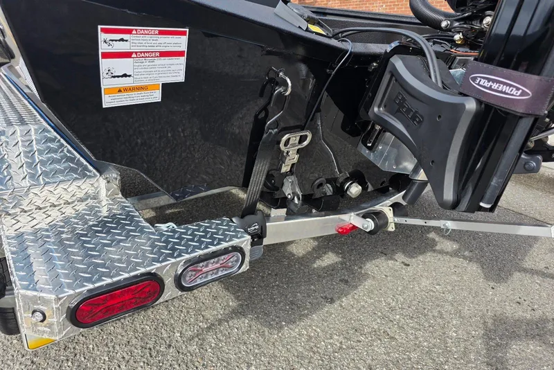 Slide: The Image of Rear view of 2026 Xpress X21 Pro boat trailer with safety warnings and diamond plate step. - 22