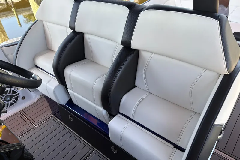 Slide: The Image of 2024 Nor-Tech 400 Supersport boat interior with luxurious white and black seating. - 10