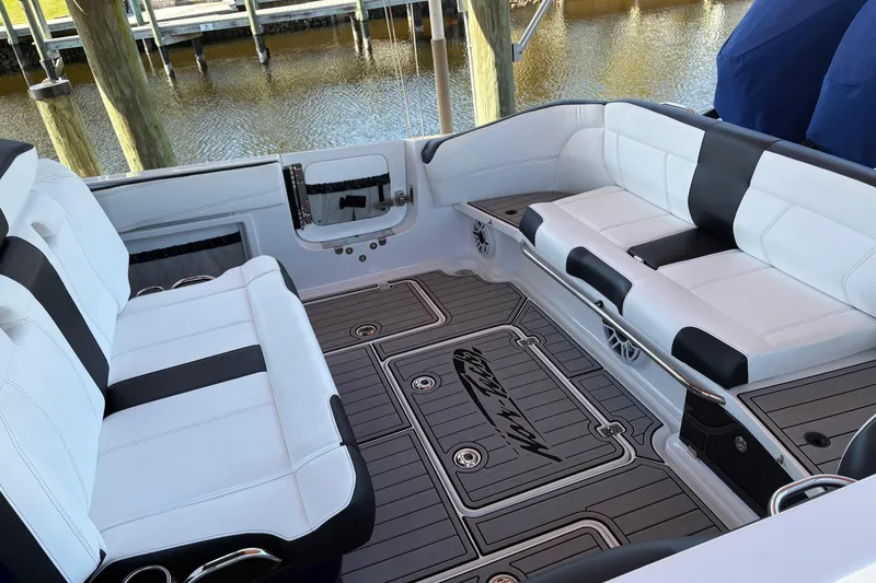 Slide: The Image of 2024 Nor-Tech 400 Supersport boat interior with sleek white seating and custom flooring. - 12
