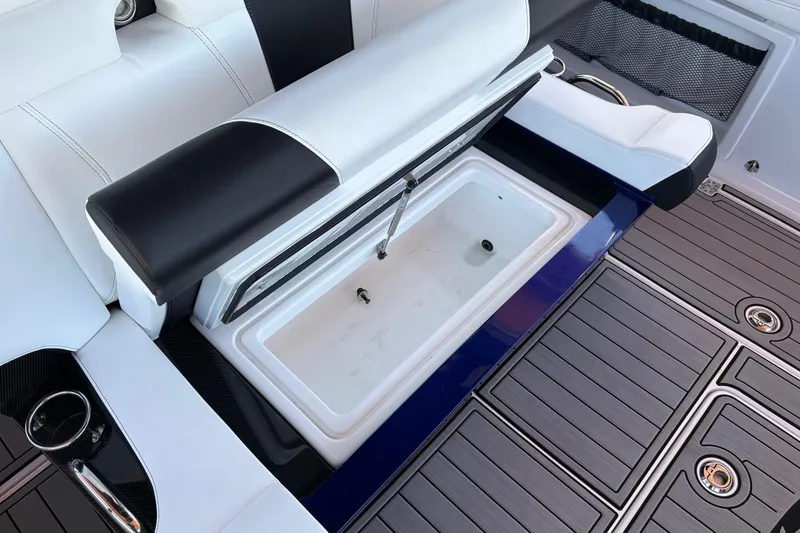 Slide: The Image of 2024 Nor-Tech 400 Supersport boat interior with open storage compartment and sleek seating. - 13