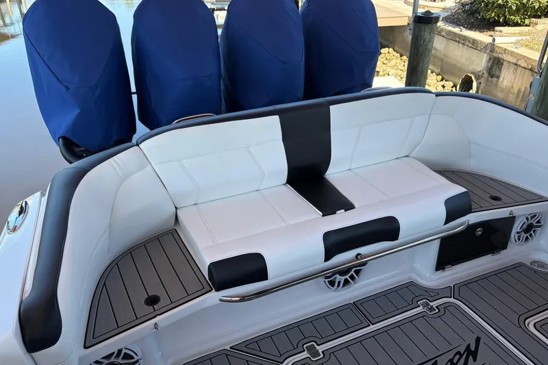 Slide: The Image of 2024 Nor-Tech 400 Supersport boat interior with cushioned seating and covered engines. - 14