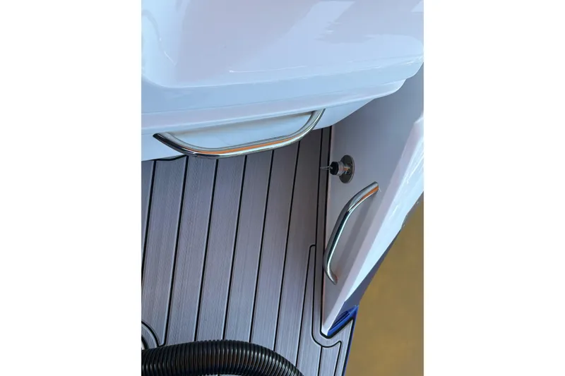 Slide: The Image of 2024 Nor-Tech 400 Supersport boat deck with sleek metal handles and modern design. - 15