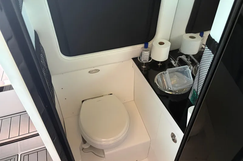 Slide: The Image of 2024 Nor-Tech 400 Supersport boat bathroom with toilet and sink. - 27
