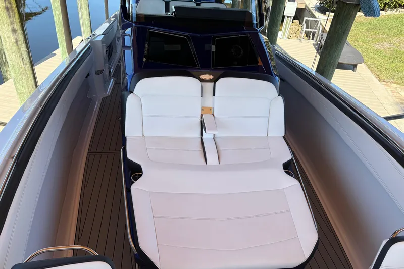Slide: The Image of 2024 Nor-Tech 400 Supersport boat with luxurious white seating and sleek design. - 8