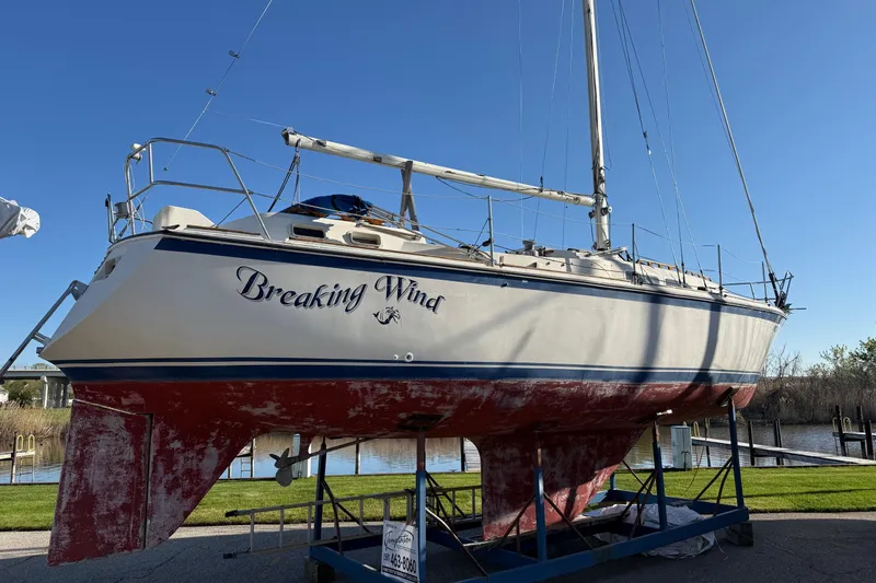 The Image of 1979 O'Day 37 sailboat "Breaking Wind" on a stand, blue sky background. - 0