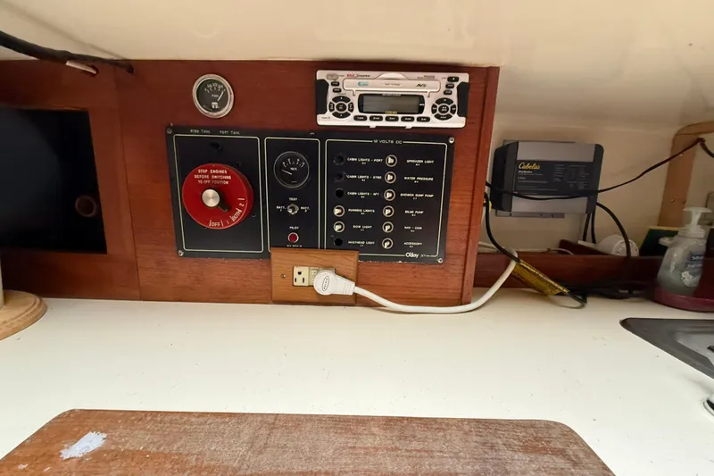 Slide: The Image of 1979 O'Day 37 yacht control panel with switches and gauges in cabin interior. - 11