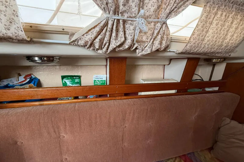 Slide: The Image of Interior of a 1979 O'Day 37 sailboat with storage and floral curtains. - 14