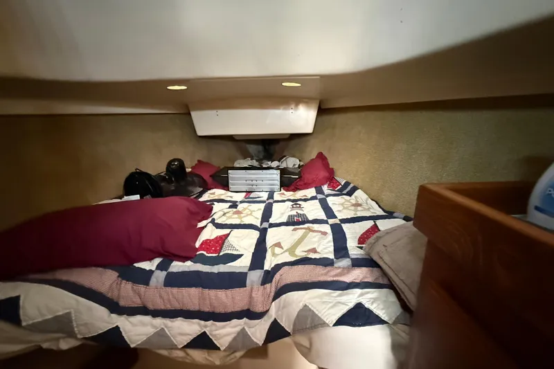Slide: The Image of Cozy cabin interior of a 1979 O'Day 37 sailboat with quilted bedding and pillows. - 18