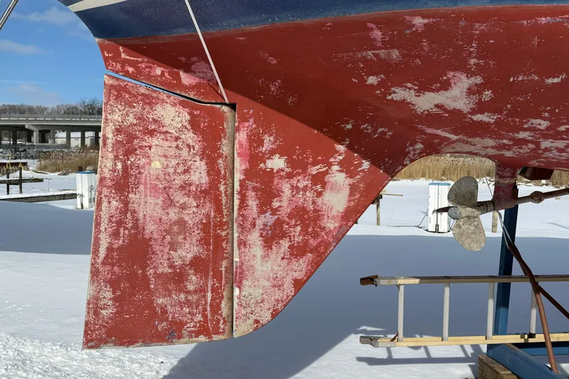 Slide: The Image of 1979 O'Day 37 sailboat rudder and propeller in snowy boatyard. - 26