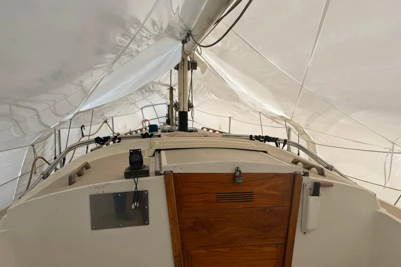 Slide: The Image of 1979 O'Day 37 sailboat interior with wooden hatch and rigging under white sails. - 4