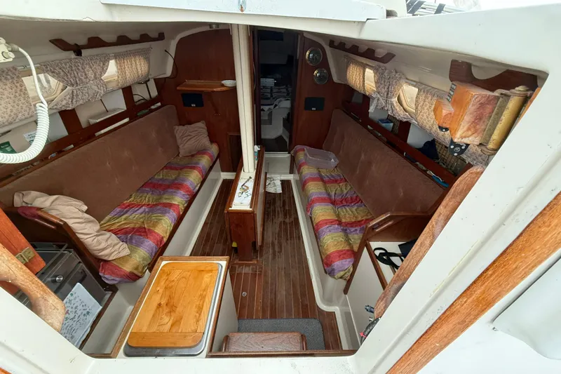 Slide: The Image of 1979 O'Day 37 sailboat interior with colorful seating and wooden accents. - 6
