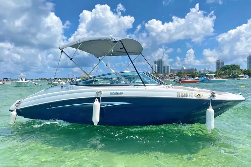 The Image of 2012 Yamaha SX190 boat docked in a sunny marina with palm trees. - 1