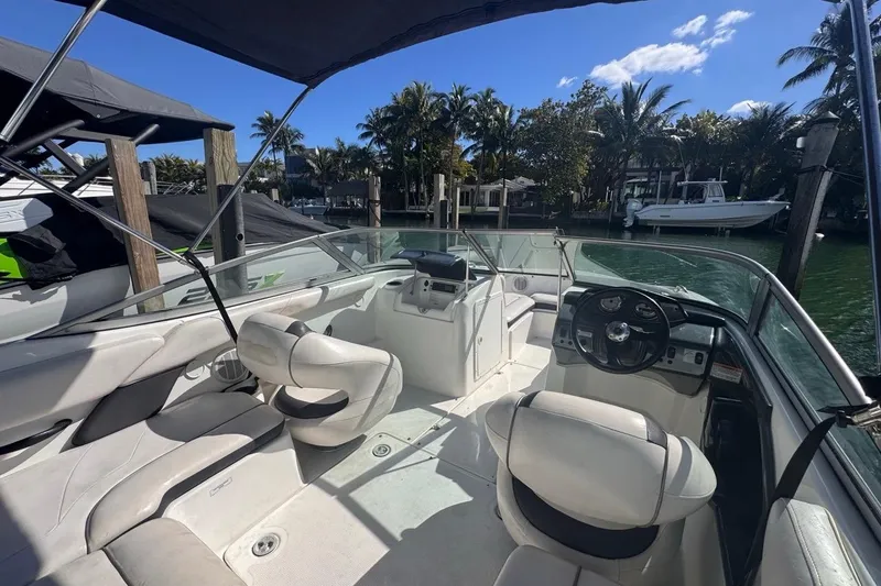 Slide: The Image of 2012 Yamaha Boats SX190 interior with steering wheel, seating, and waterfront view. - 13