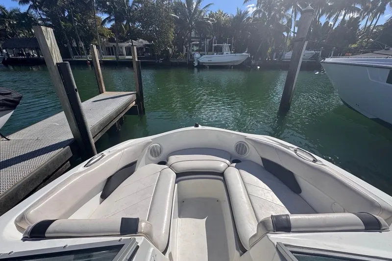 Slide: The Image of 2012 Yamaha Boats SX190 docked, featuring spacious seating and scenic waterfront view. - 26